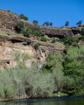 The dramatic cliffs of Goodwin Canyon in the background as a fly angler fishes a run.