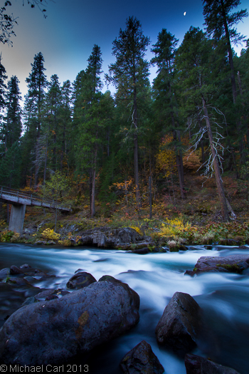 A moon lights Northern California's McCloud River in Fall