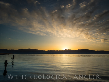Fisherman on the shore of Pyramid Lake in Nevada working the pre dawn light before the sun rises.