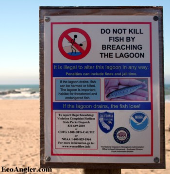 Sign warning against breaching sandbar at mouth of lagoon